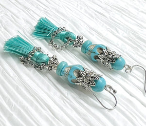 Fancy turquoise Wagnerite skull earrings with sparkling crown and tassel skirt