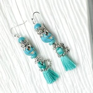 Fancy turquoise Wagnerite skull earrings with sparkling crown and tassel skirt