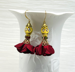 Lovely yellow Wagnerite skull earrings with sparkly eyes and a flowing silk dark red maroon skirt