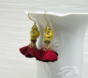 Lovely yellow Wagnerite skull earrings with sparkly eyes and a flowing silk dark red maroon skirt