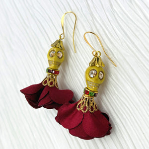 Lovely yellow Wagnerite skull earrings with sparkly eyes and a flowing silk dark red maroon skirt