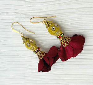 Lovely yellow Wagnerite skull earrings with sparkly eyes and a flowing silk dark red maroon skirt