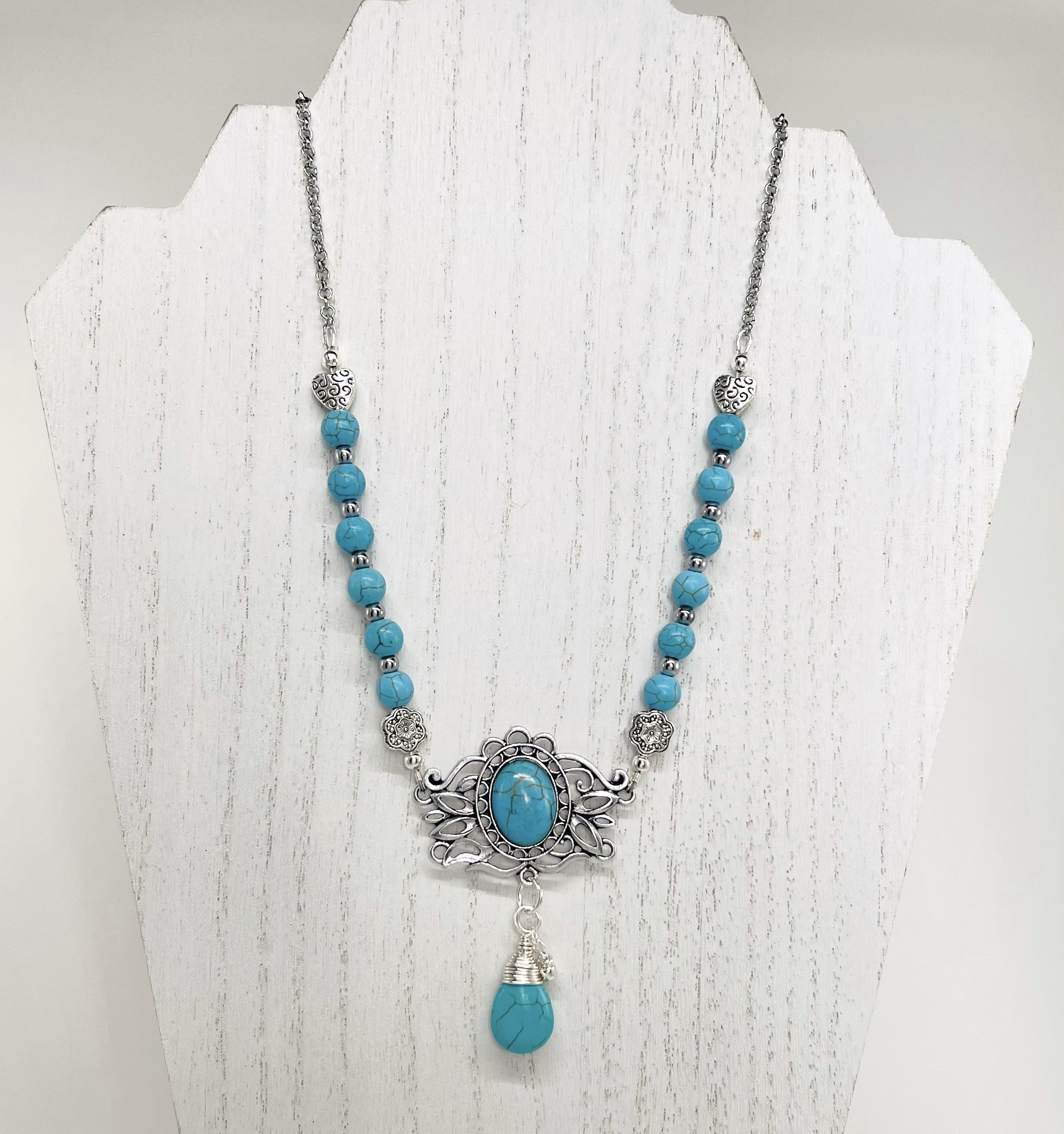 Statement necklace and earring set in turquoise howlite beads, silver accents and stunning ornately styled silver and turquoise focal