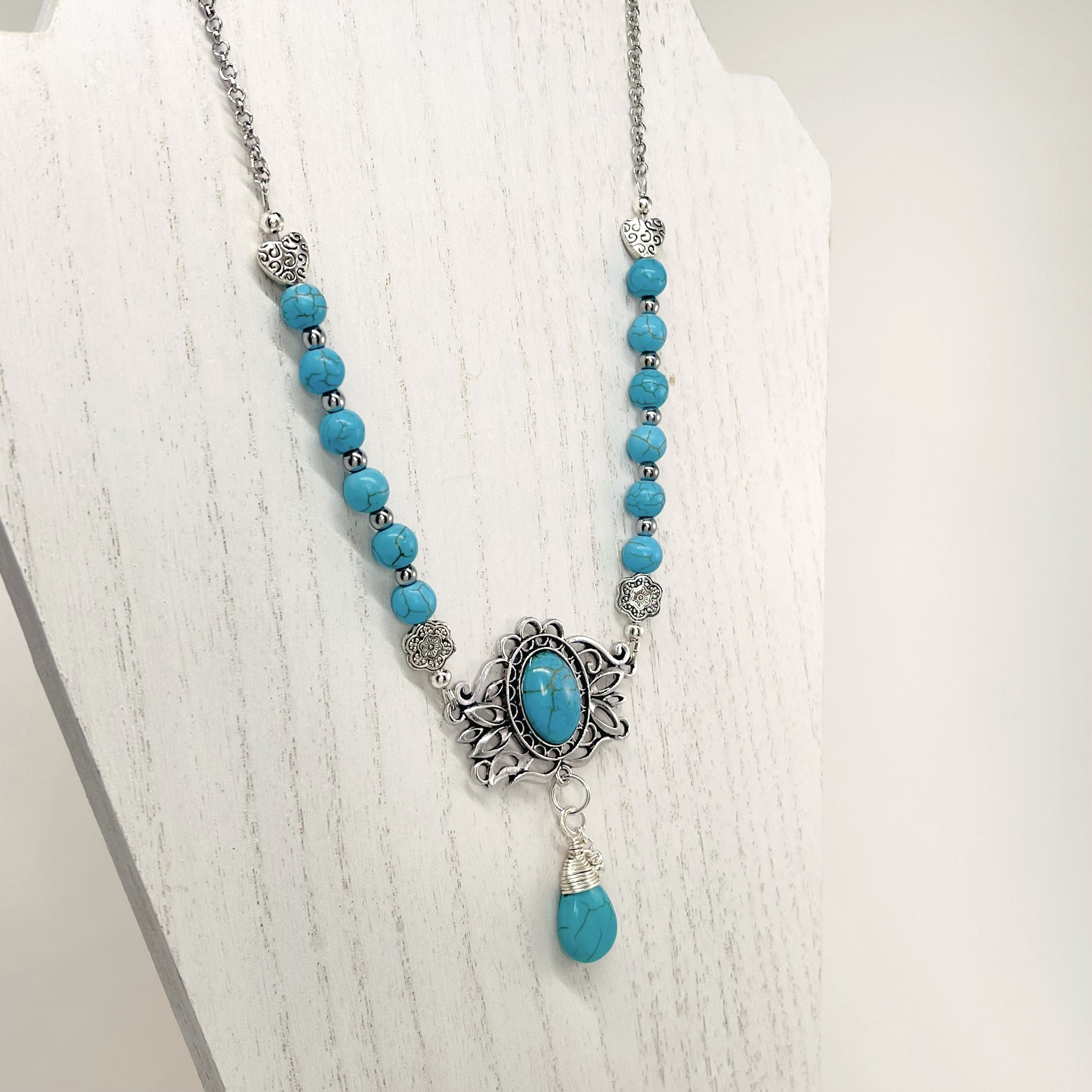 Statement necklace and earring set in turquoise howlite beads, silver accents and stunning ornately styled silver and turquoise focal