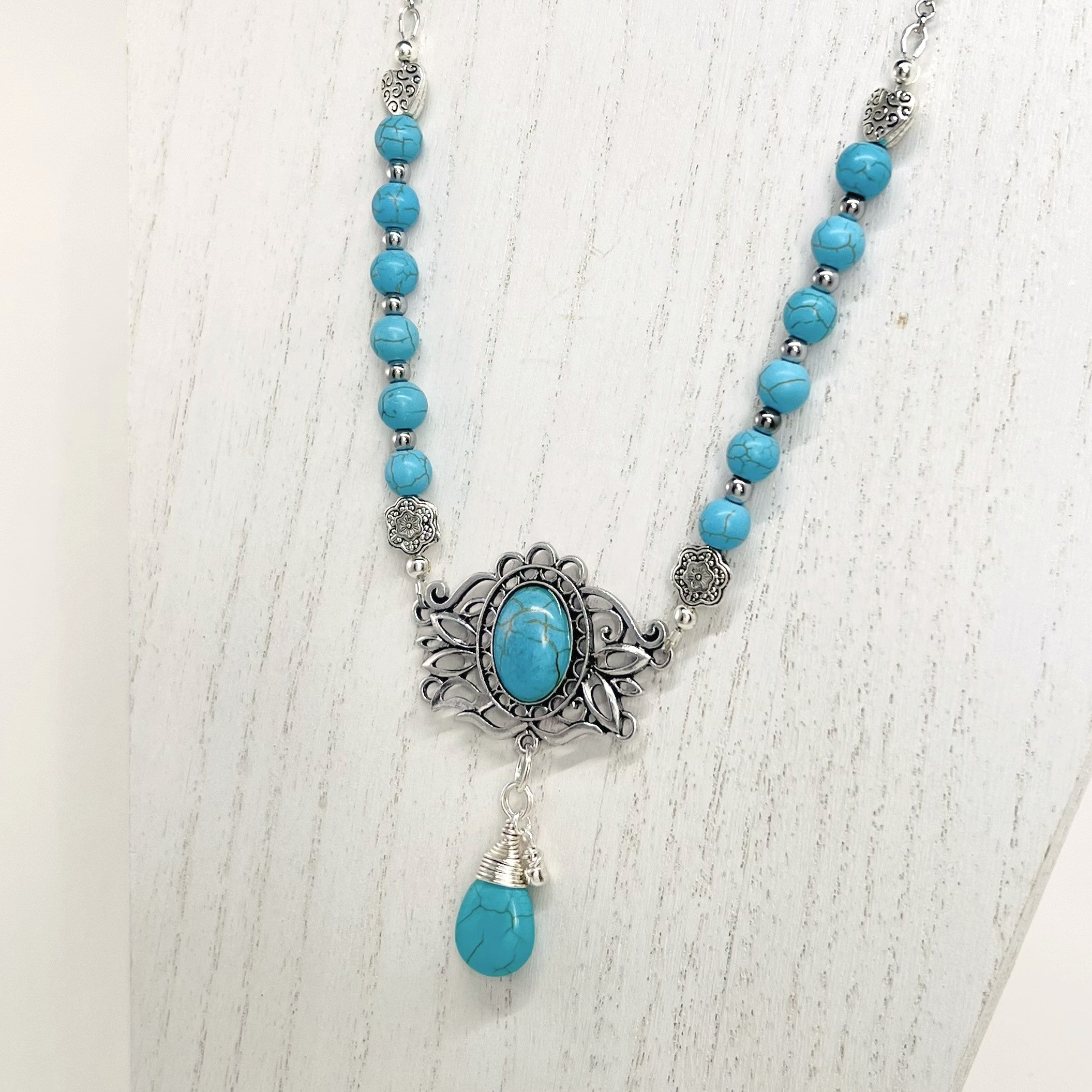 Statement necklace and earring set in turquoise howlite beads, silver accents and stunning ornately styled silver and turquoise focal