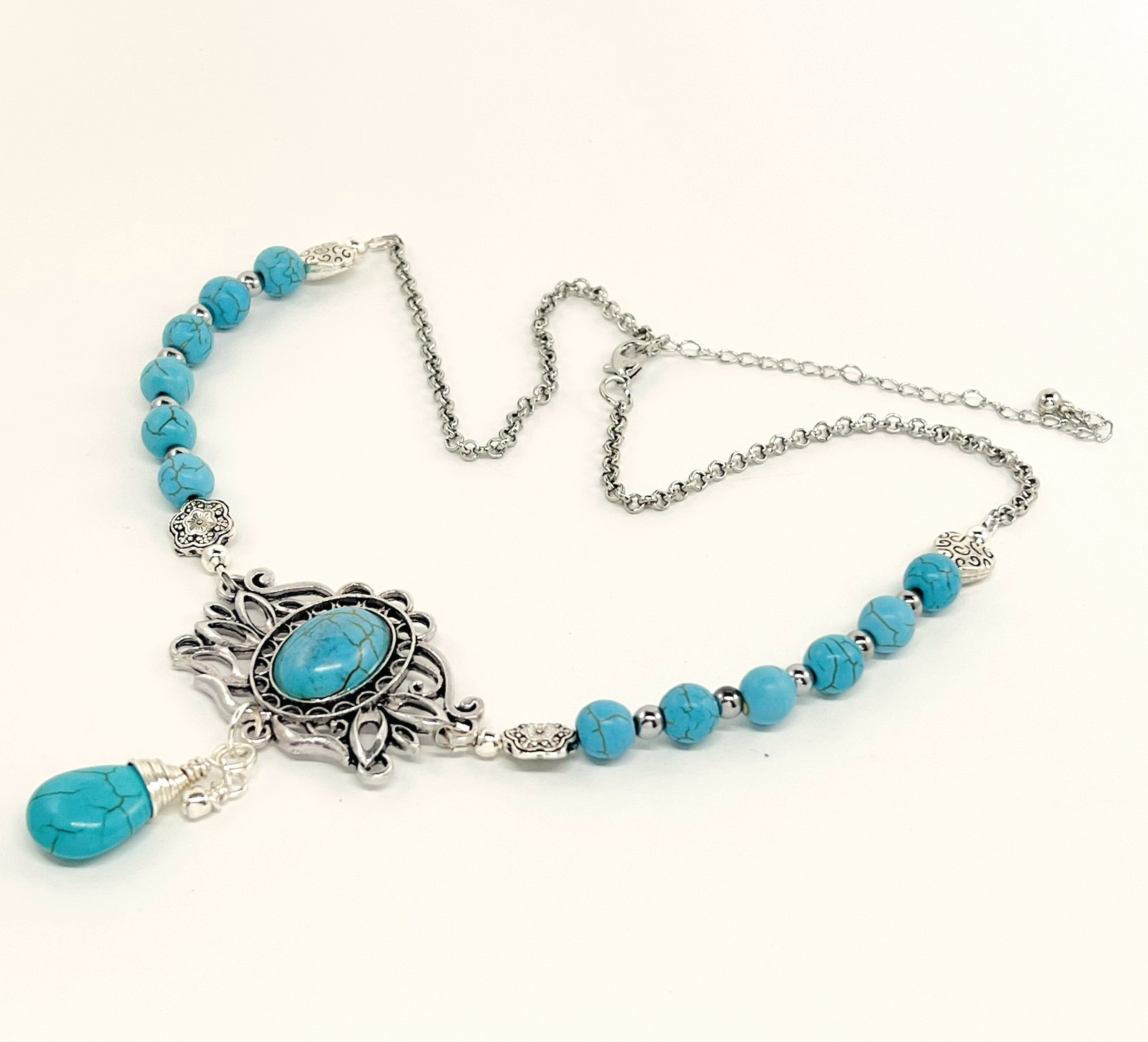 Statement necklace and earring set in turquoise howlite beads, silver accents and stunning ornately styled silver and turquoise focal