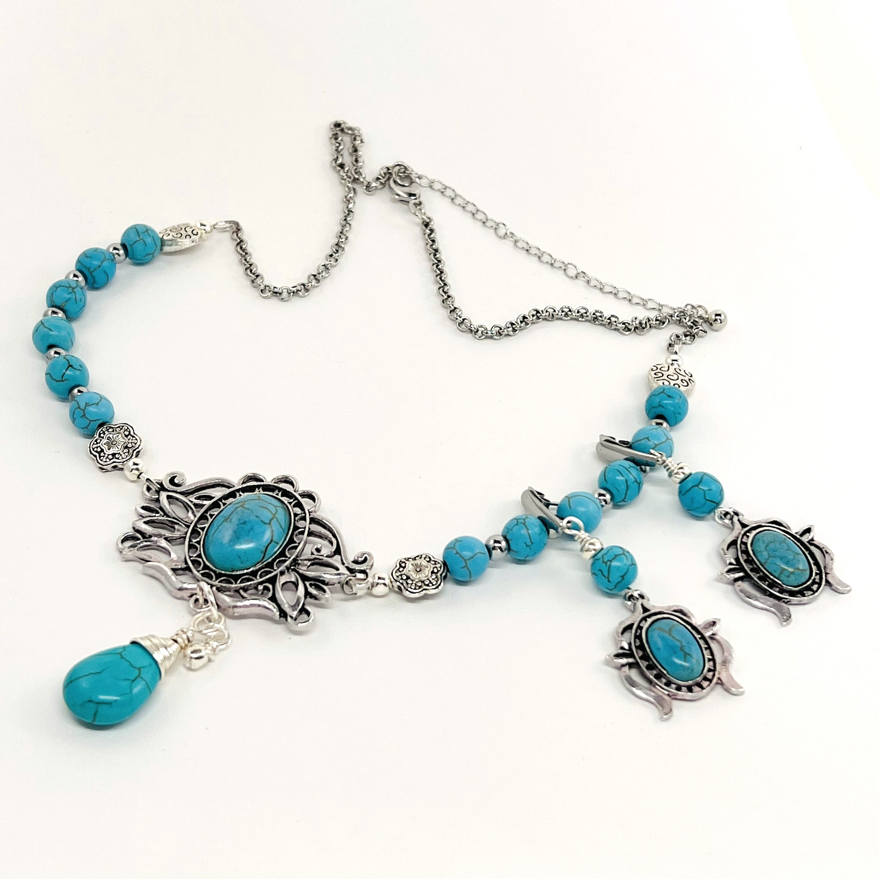 Statement necklace and earring set in turquoise howlite beads, silver accents and stunning ornately styled silver and turquoise focal