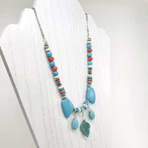 Statement necklace and earring set of turquoise howlite stones with cream, orange and silver accents