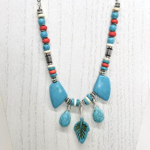 Statement necklace and earring set of turquoise howlite stones with cream, orange and silver accents