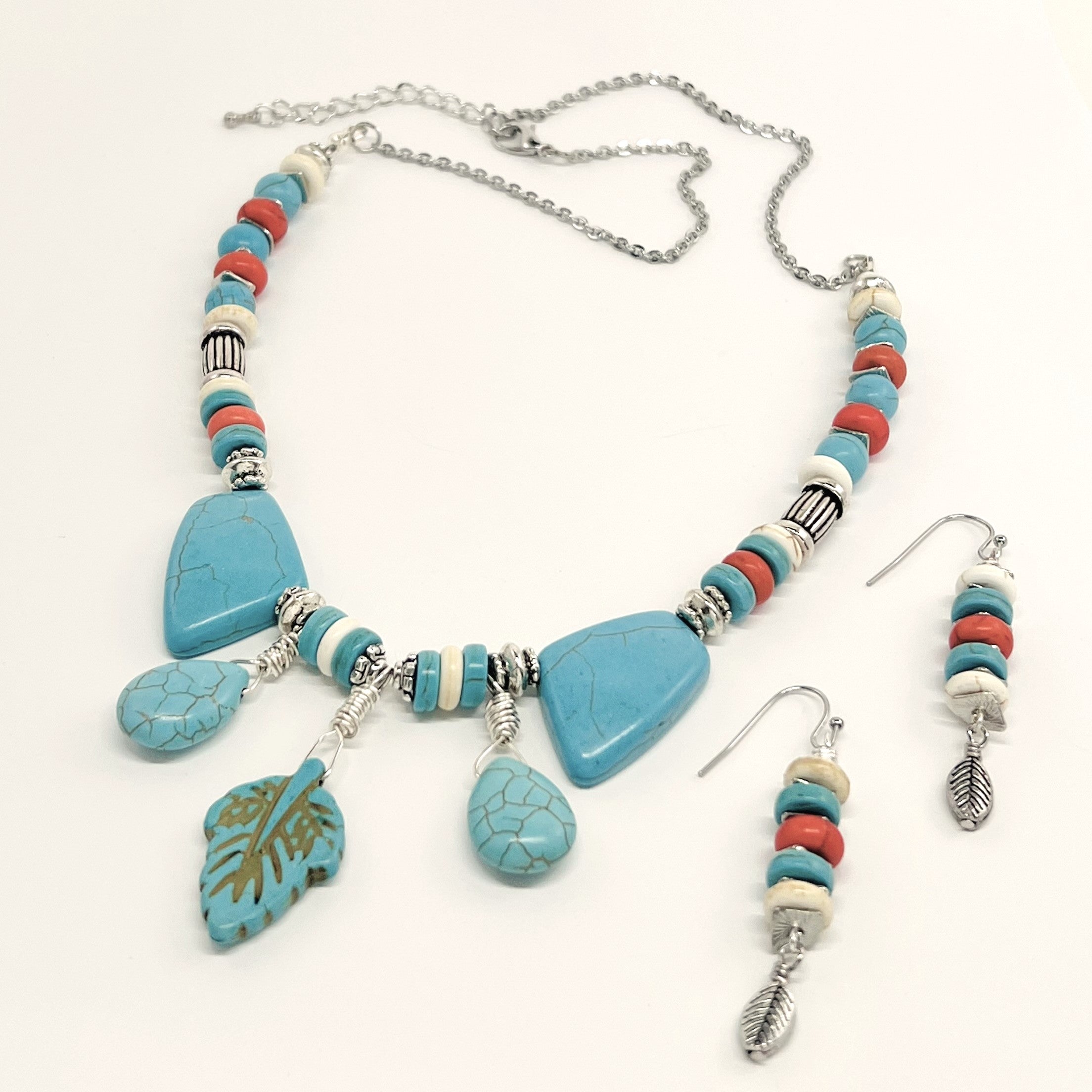 Statement necklace and earring set of turquoise howlite stones with cream, orange and silver accents