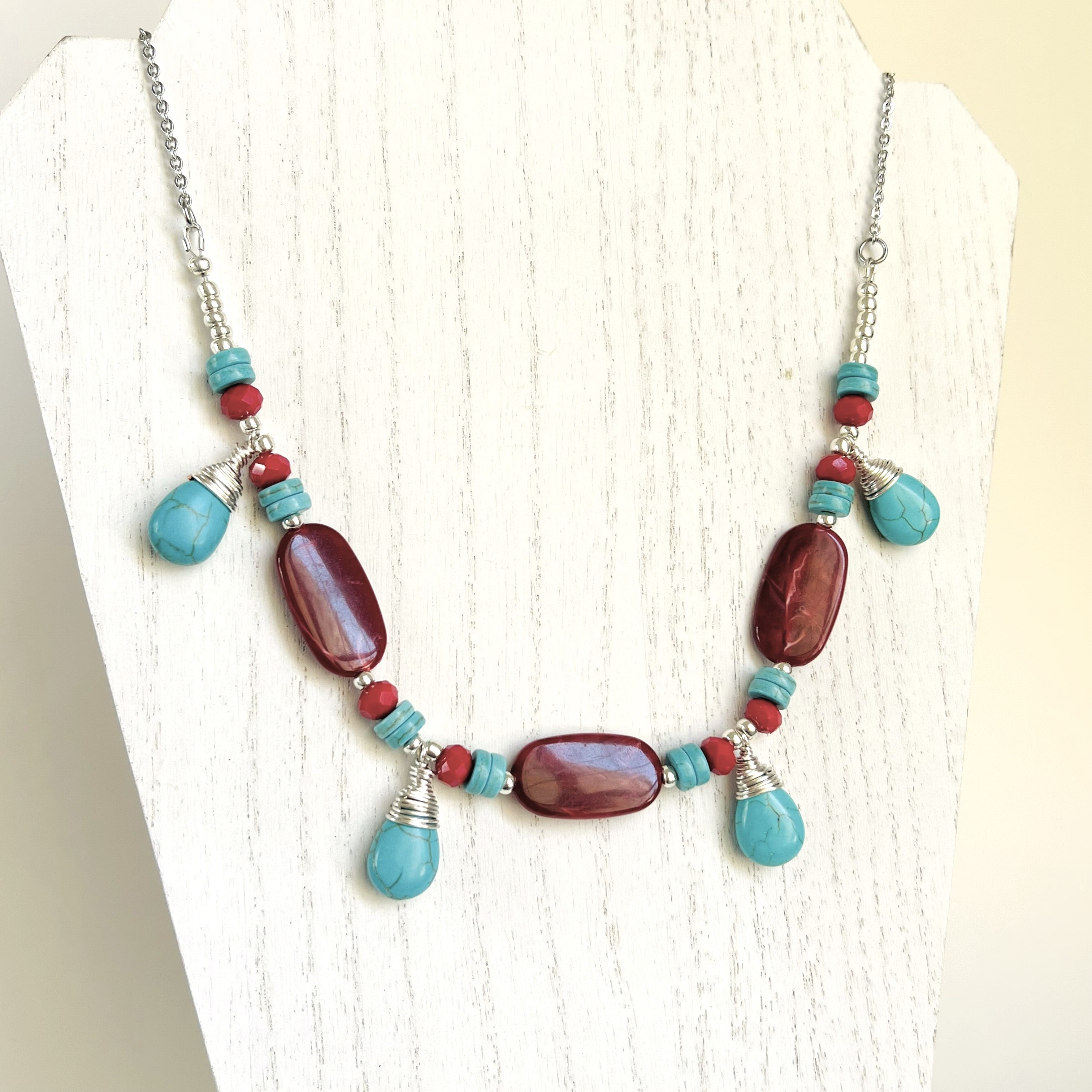 Statement necklace and earring set in turquoise howlite and deep red acrylic beads with silver accents