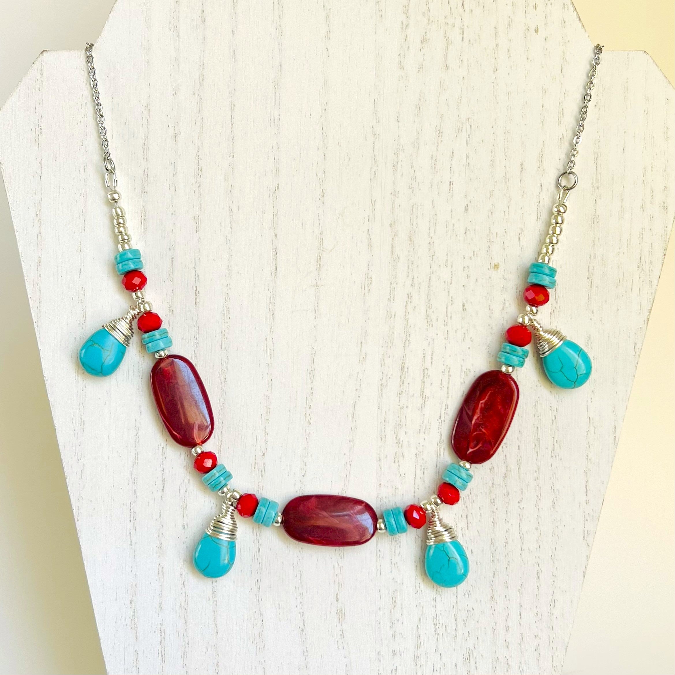 Statement necklace and earring set in turquoise howlite and deep red acrylic beads with silver accents