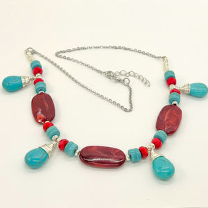 Statement necklace and earring set in turquoise howlite and deep red acrylic beads with silver accents