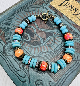 Bracelet and earring set in antique bronze, turquoise howlite and orange glass beads