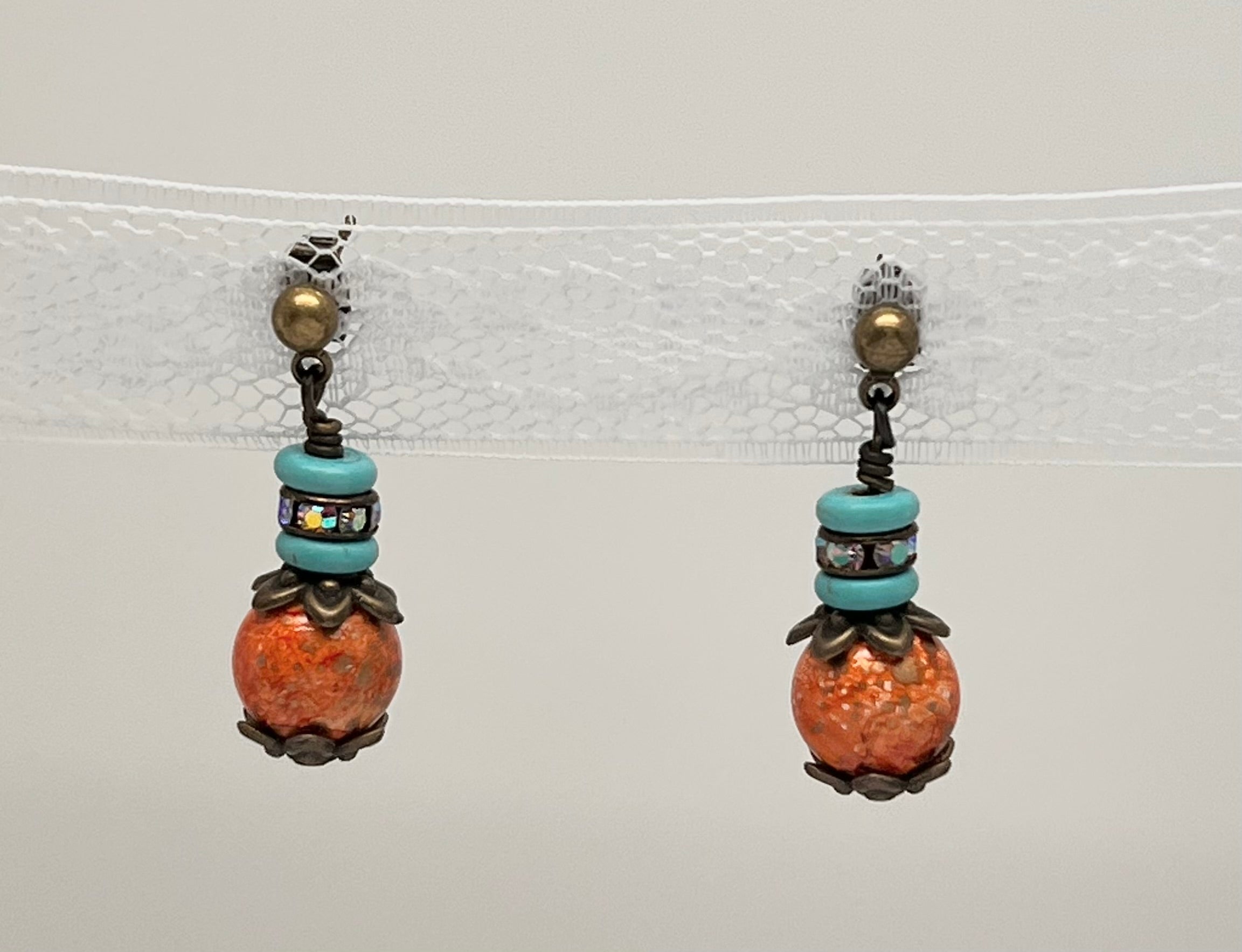 Bracelet and earring set in antique bronze, turquoise howlite and orange glass beads