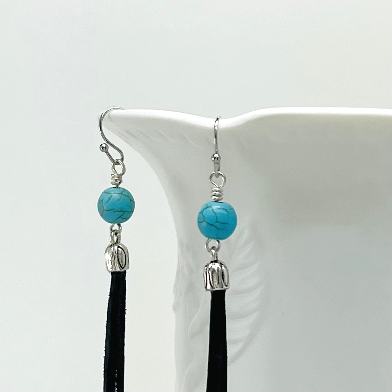 Leather earrings with turquoise Howlite stone beads with silver accents