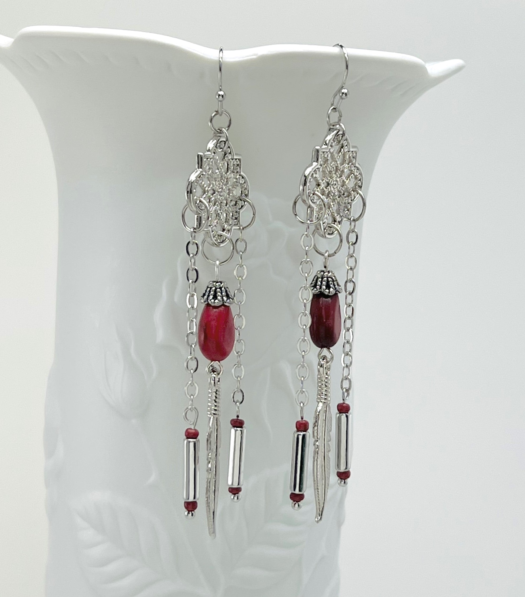 Powerful red stone tear drop earrings with silver accents and feather charms