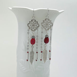 Powerful red stone tear drop earrings with silver accents and feather charms